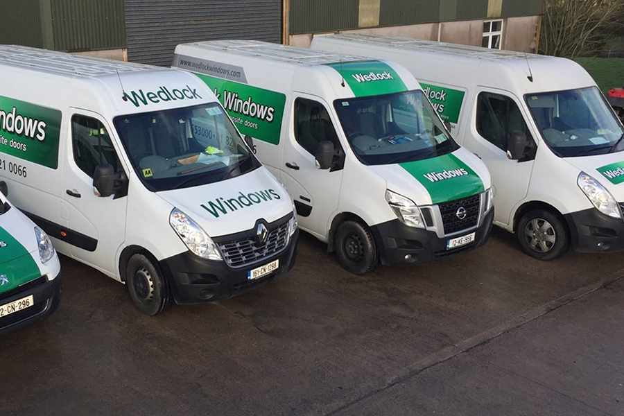 several white vans with wedlockw indows branding
