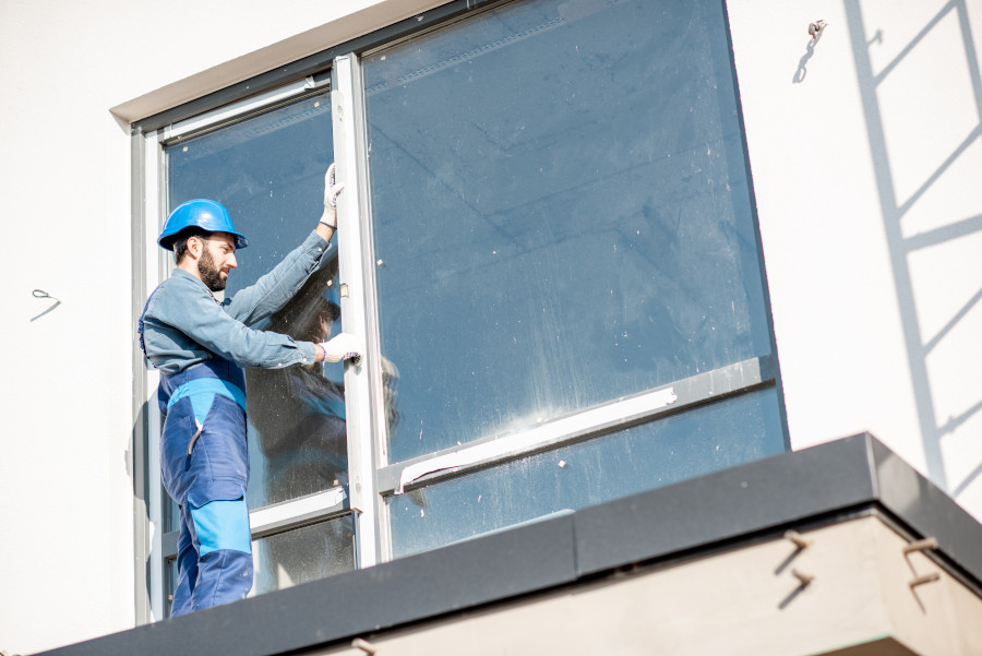 a man installing an office window